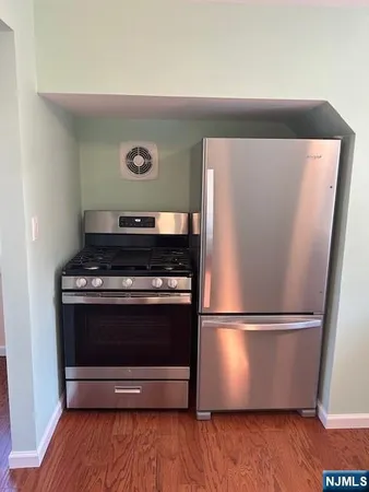 a view of washer and dryer with wooden floor