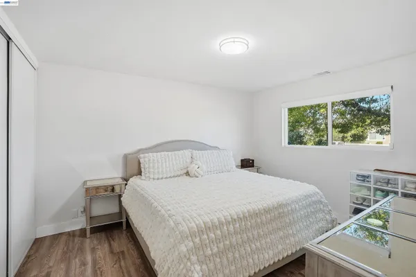 a bedroom with a bed and a desk