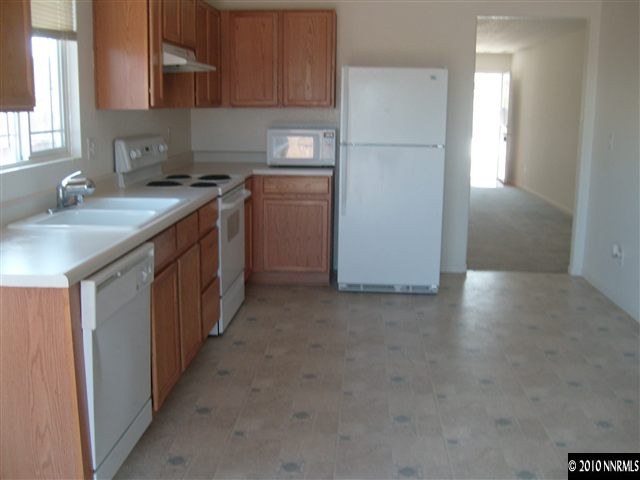7701 Corso Street Reno, NV 89506 - Photo 8 of 8 a kitchen with stainless steel appliances granite countertop a sink stove and refrigerator