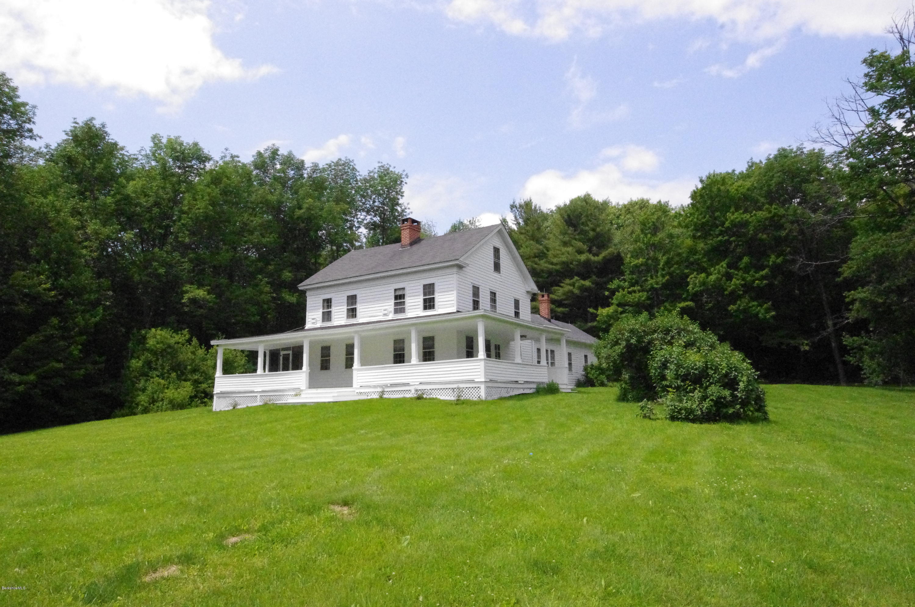 40 Cronk Road Sandisfield, MA 01255 - Photo 2 of 10 a front view of a house with a yard table and chairs