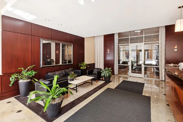 a lobby with furniture and potted plant
