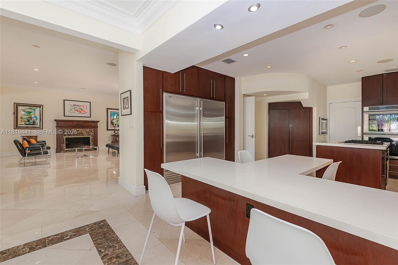 6535 Allison Road Miami Beach, FL 33141 - Photo 12 of 60 a living room with stainless steel appliances furniture a fireplace and a kitchen view