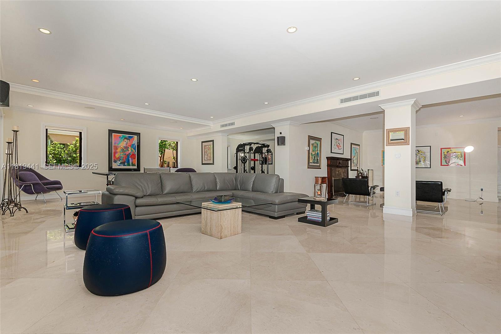 6535 Allison Road Miami Beach, FL 33141 - Photo 16 of 60 a living room with couches and a dining table with wooden floor