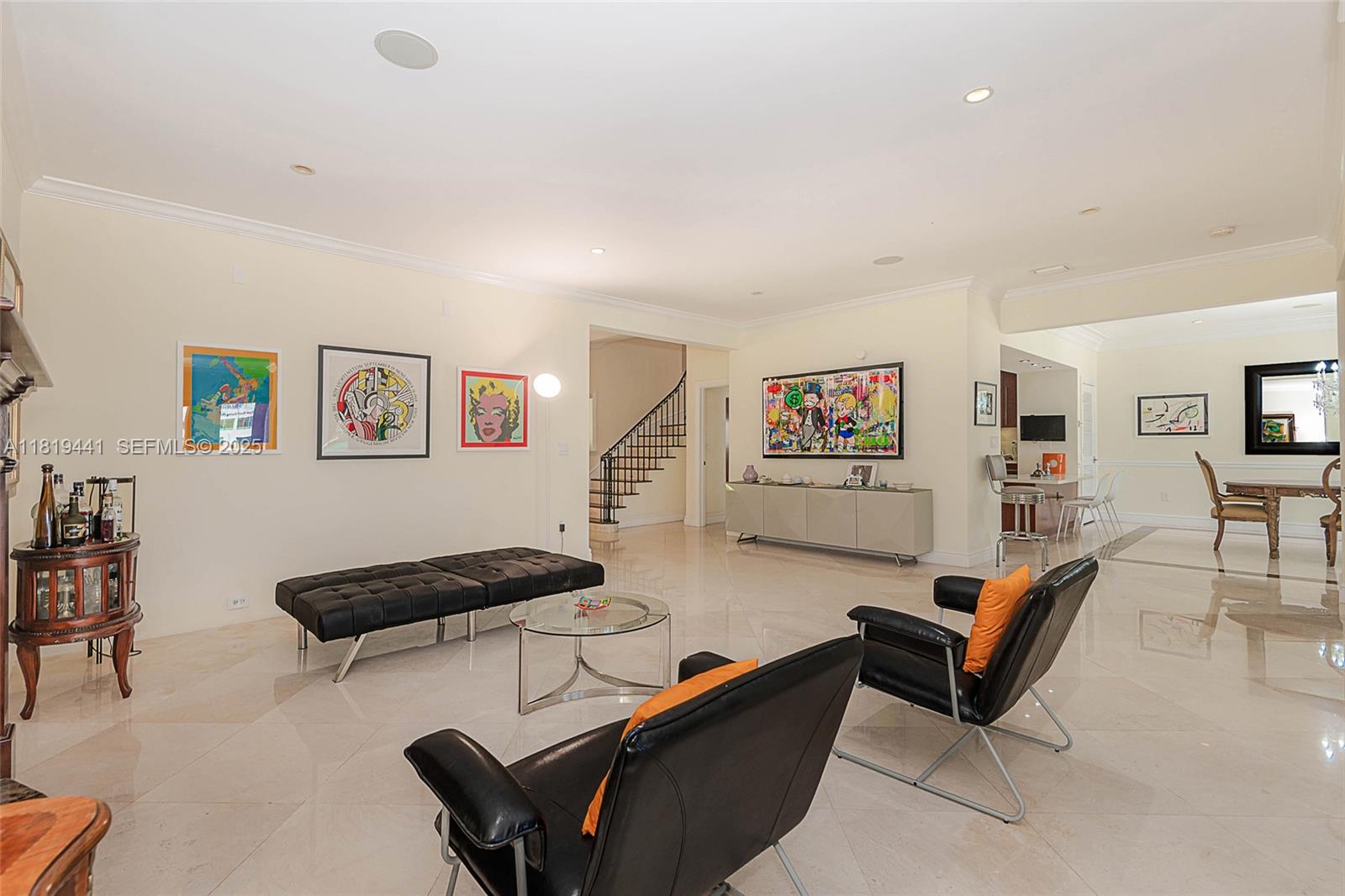 6535 Allison Road Miami Beach, FL 33141 - Photo 17 of 60 a living room with furniture a couch and a bookshelf with wooden floor