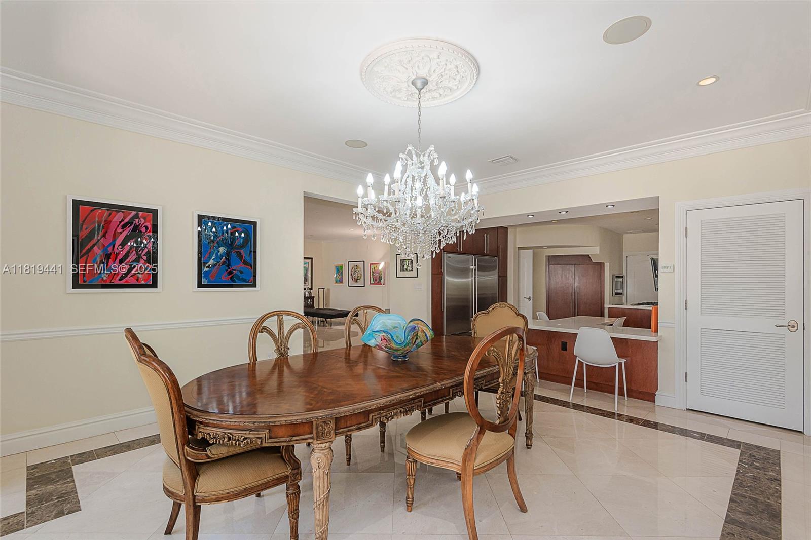 6535 Allison Road Miami Beach, FL 33141 - Photo 28 of 60 a view of a dining room with furniture and chandelier