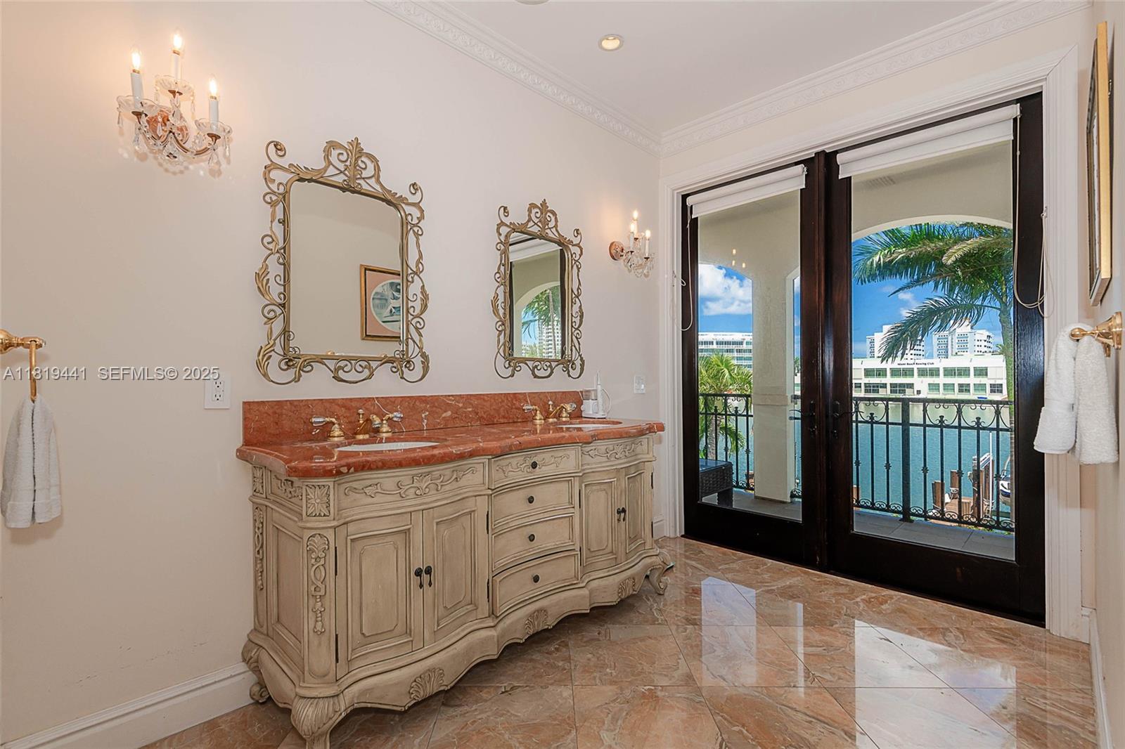 6535 Allison Road Miami Beach, FL 33141 - Photo 33 of 60 a spacious bathroom with a double vanity sink and a mirror