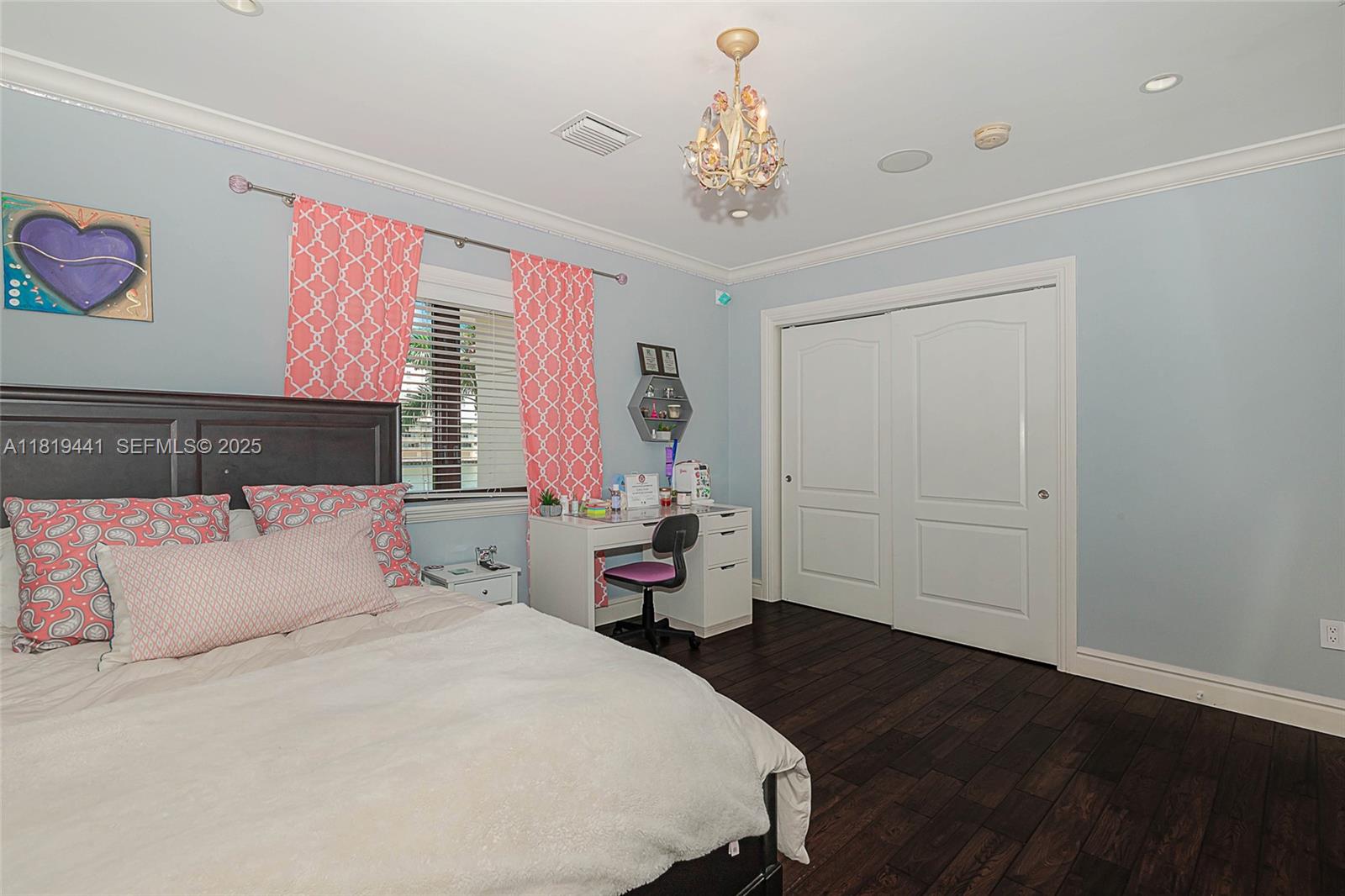 6535 Allison Road Miami Beach, FL 33141 - Photo 43 of 60 a bedroom with a bed and a chandelier