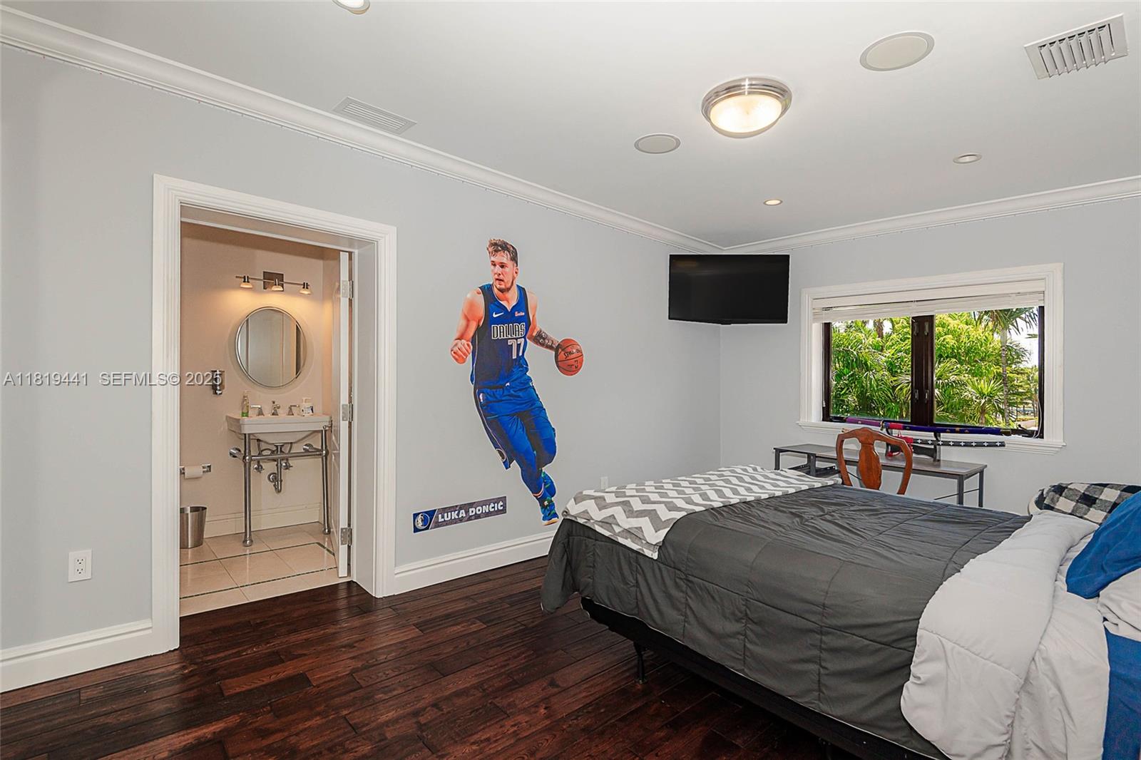 6535 Allison Road Miami Beach, FL 33141 - Photo 44 of 60 a bed room with a bed and a window