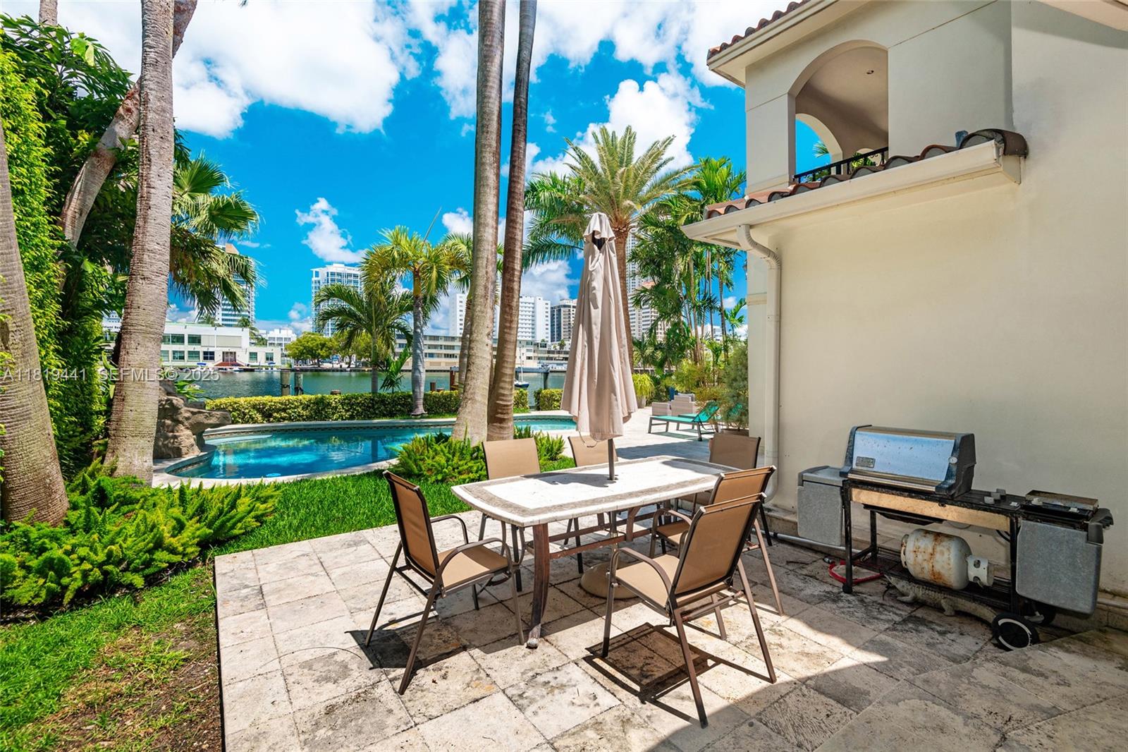 6535 Allison Road Miami Beach, FL 33141 - Photo 49 of 60 a view of a patio with table and chairs and potted plants