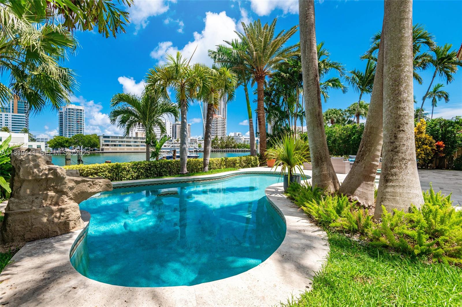 6535 Allison Road Miami Beach, FL 33141 - Photo 51 of 60 a view of a swimming pool with a garden