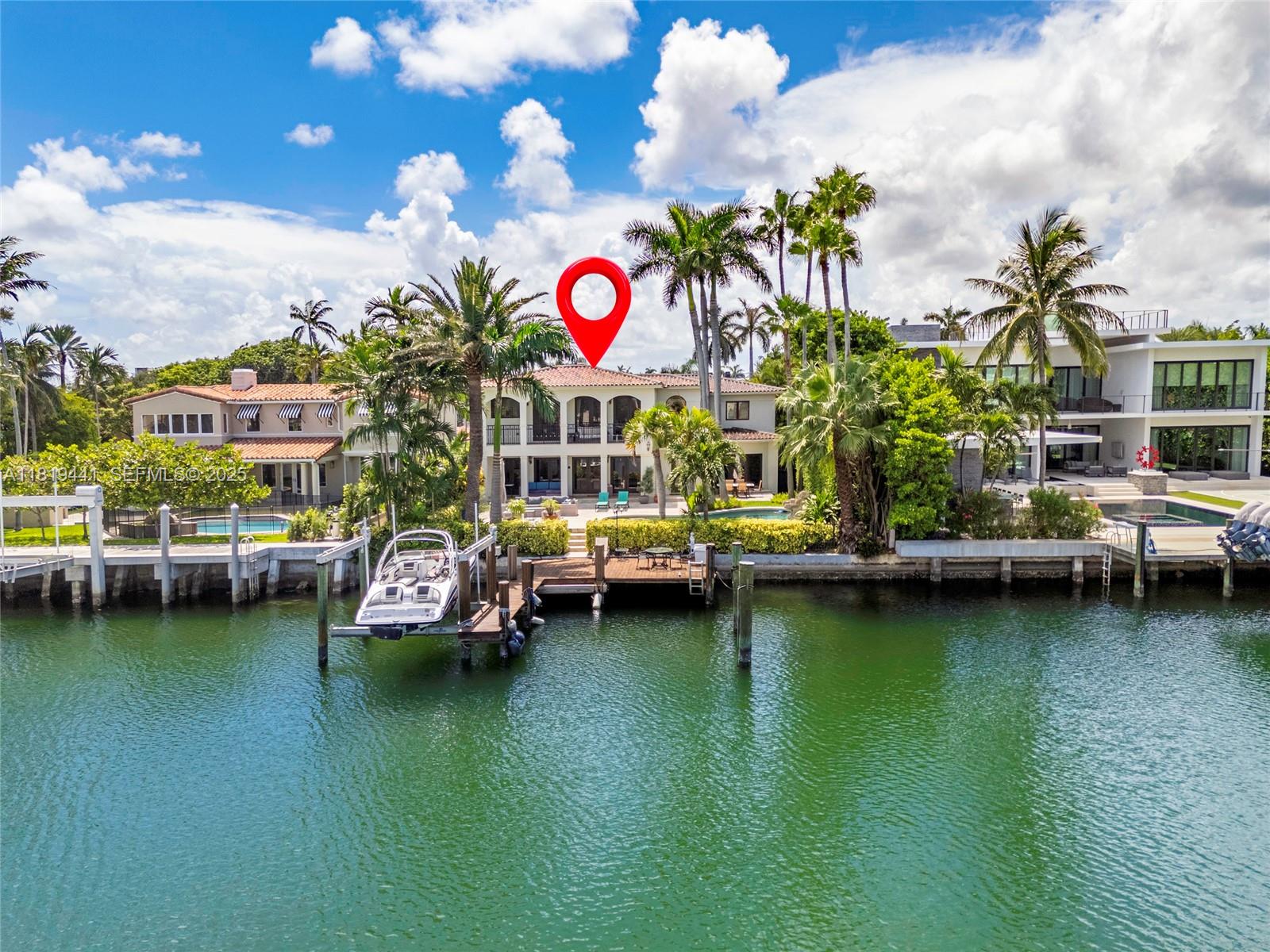 6535 Allison Road Miami Beach, FL 33141 - Photo 9 of 60 a view of a swimming pool with a lawn chairs and potted plants