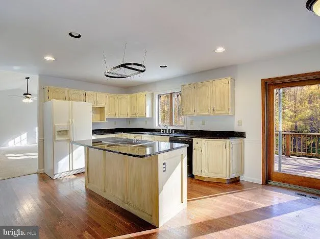 a kitchen with stainless steel appliances granite countertop a stove top oven a sink a counter space and cabinets