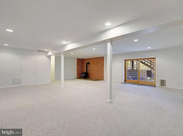 a view of an empty room with a chandelier fan