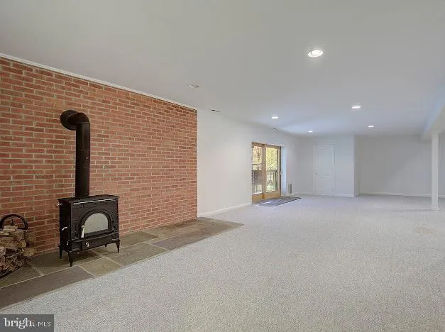 en empty room with windows and chandelier fan
