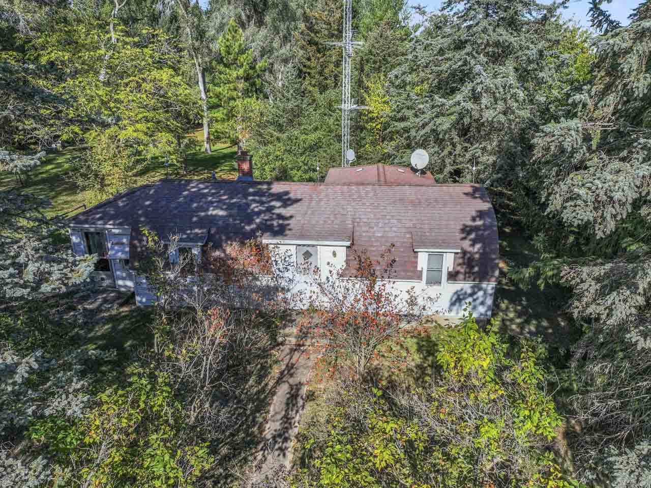 10330 336th Avenue Randall, WI 53181 - Photo 21 of 29 a aerial view of a house with a yard and large trees