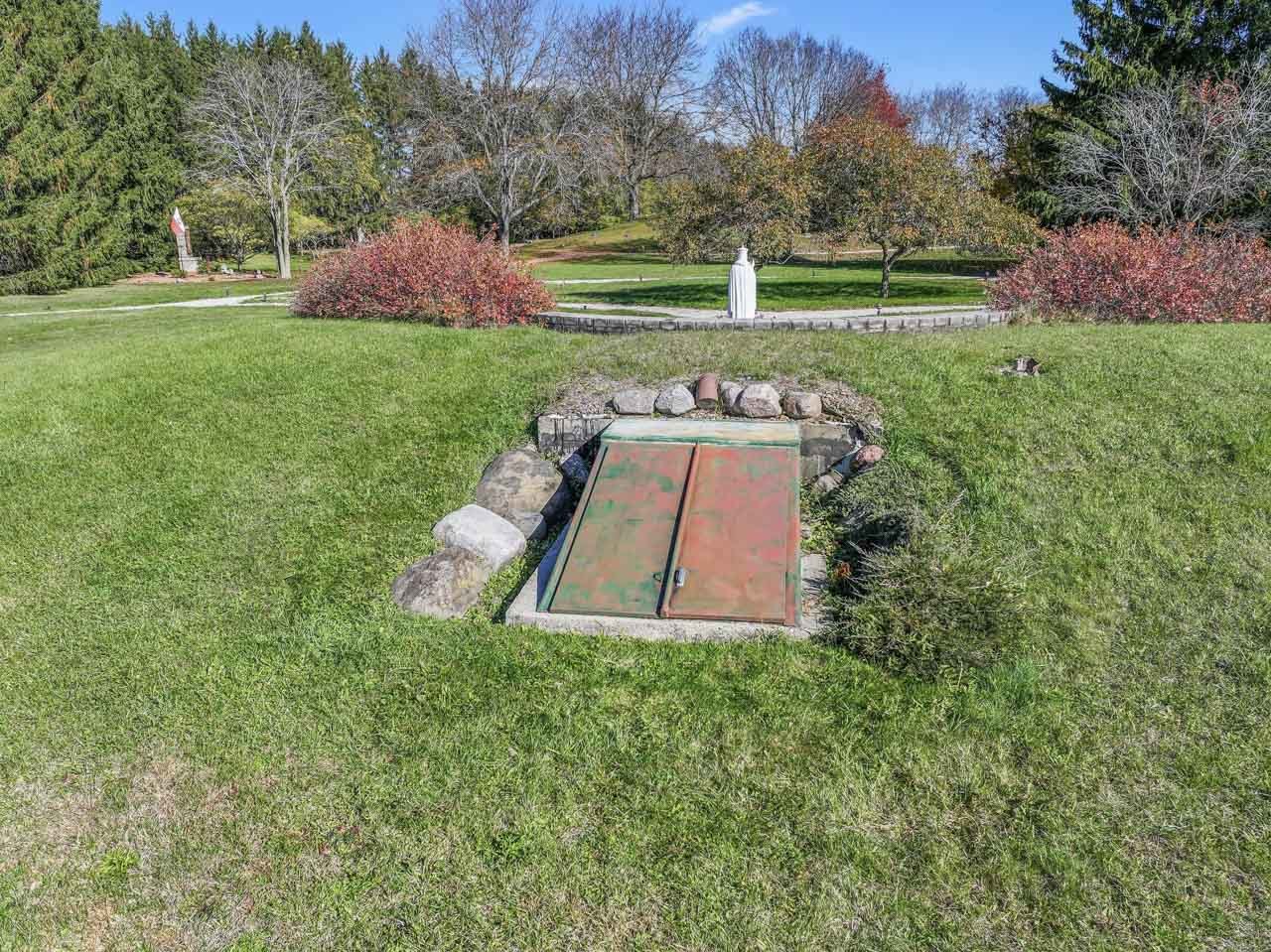 10330 336th Avenue Randall, WI 53181 - Photo 24 of 29 a garden with trees in front of it