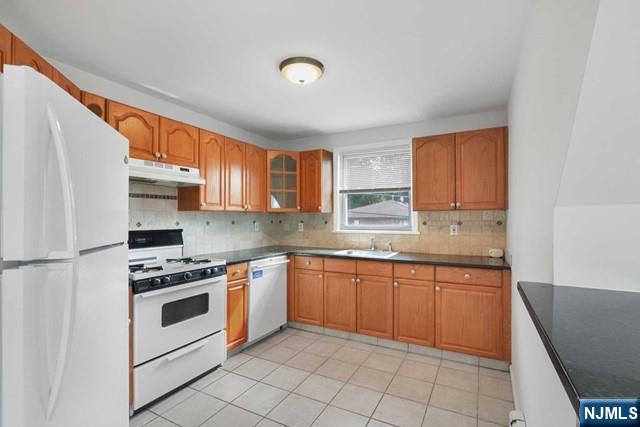 39 Springfield Avenue, Unit 2 Hasbrouck Heights, NJ 07604 - Photo 3 of 13 a kitchen with granite countertop cabinets stainless steel appliances and a sink