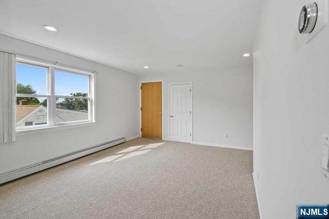 39 Springfield Avenue, Unit 2 Hasbrouck Heights, NJ 07604 - Photo 4 of 13 a view of an empty room with a window