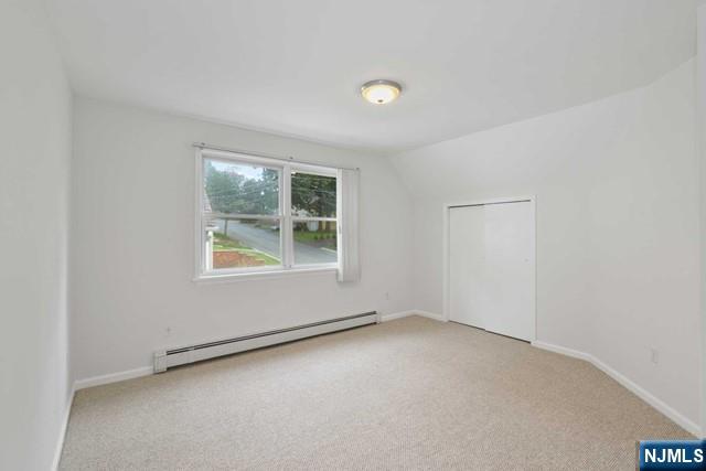 39 Springfield Avenue, Unit 2 Hasbrouck Heights, NJ 07604 - Photo 6 of 13 an empty room with a window