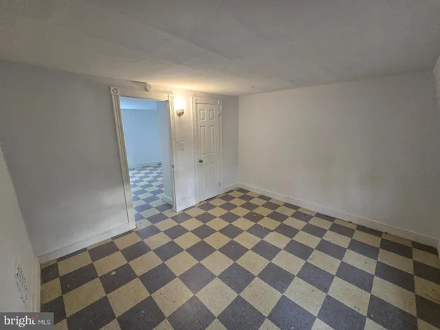 a view of a bathroom with a black and white checkered floor