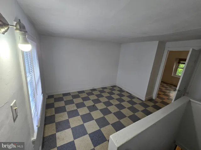 a bathroom with a black and white checkered floor