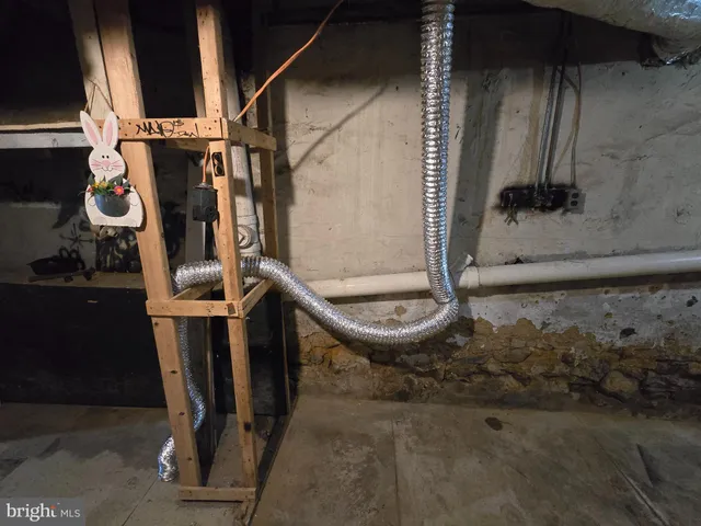a view of water heater room with wooden floor