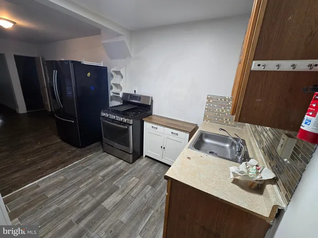 a kitchen with a stove and a refrigerator