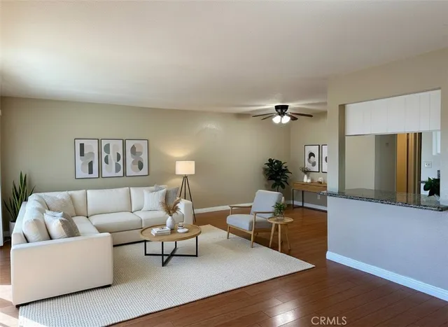 a living room with furniture and a wooden floor
