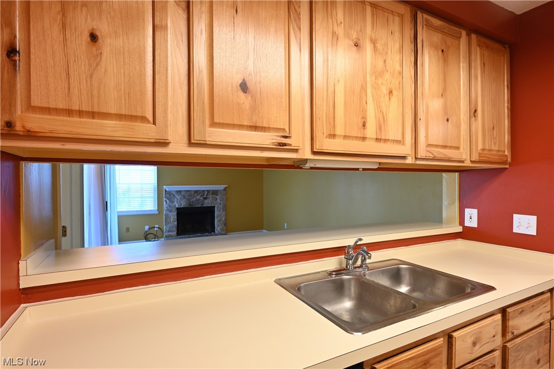 28140 Detroit Road, Unit A1 Westlake, OH 44145 - Photo 13 of 30 Kitchen featuring a premium fireplace and sink