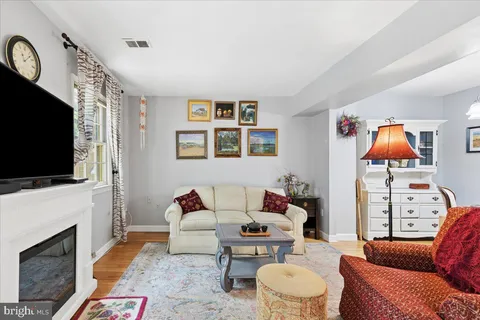 a living room with furniture fireplace and flat screen tv