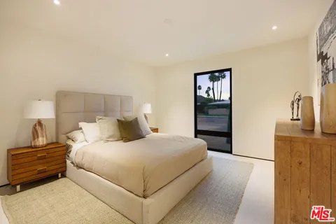 a bedroom with a bed and dresser