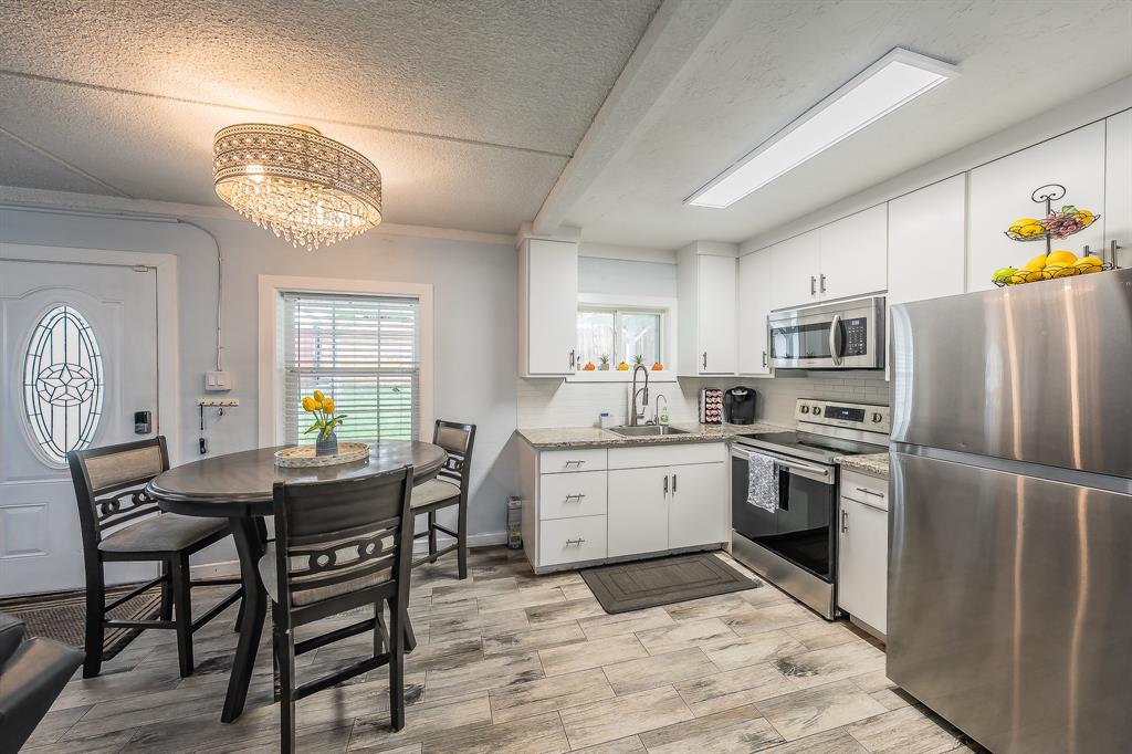 14064 Rucker Street Azle, TX 76020 - Photo 13 of 40 a kitchen with a refrigerator a table chairs and a refrigerator
