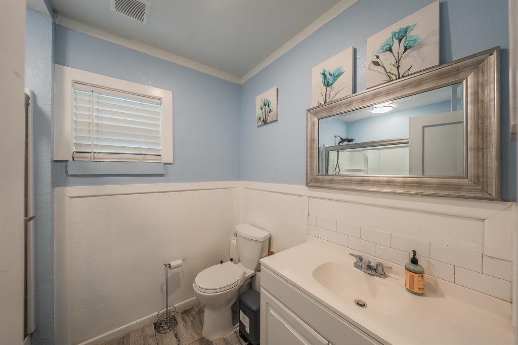 14064 Rucker Street Azle, TX 76020 - Photo 14 of 40 a bathroom with a sink mirror and toilet