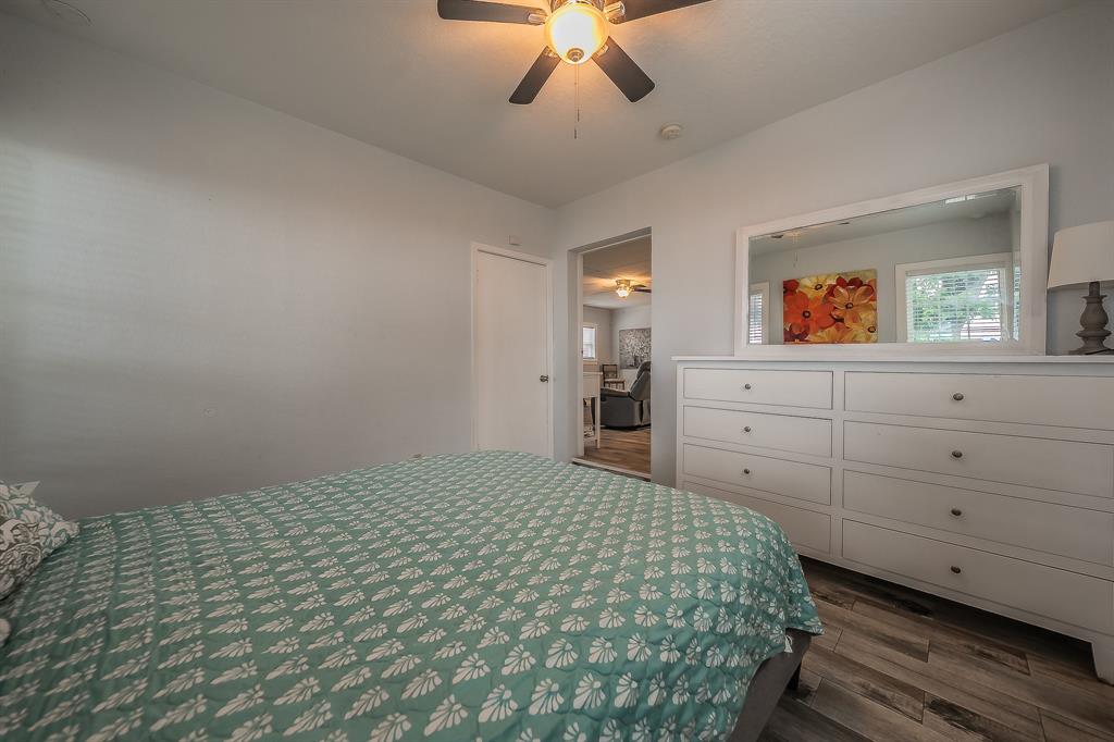 14064 Rucker Street Azle, TX 76020 - Photo 18 of 40 a bedroom with a bed and a chandelier