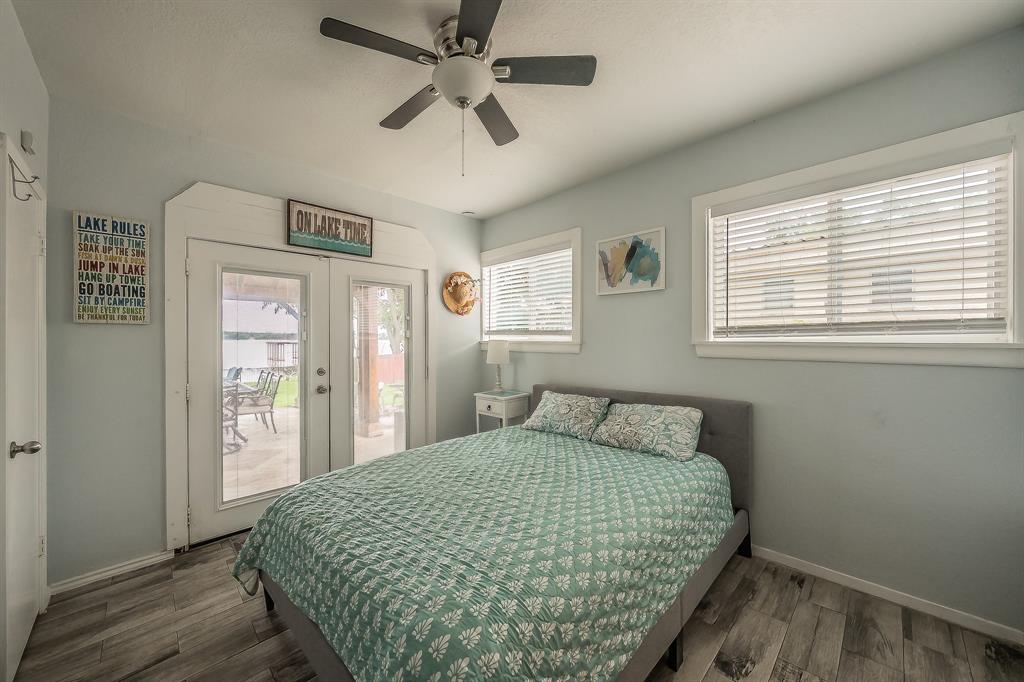 14064 Rucker Street Azle, TX 76020 - Photo 19 of 40 a bedroom with a large bed and a chandelier
