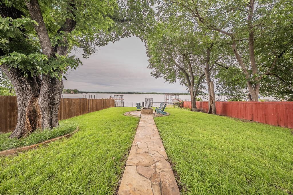 14064 Rucker Street Azle, TX 76020 - Photo 28 of 40 a view of swimming pool with table and chairs under an umbrella