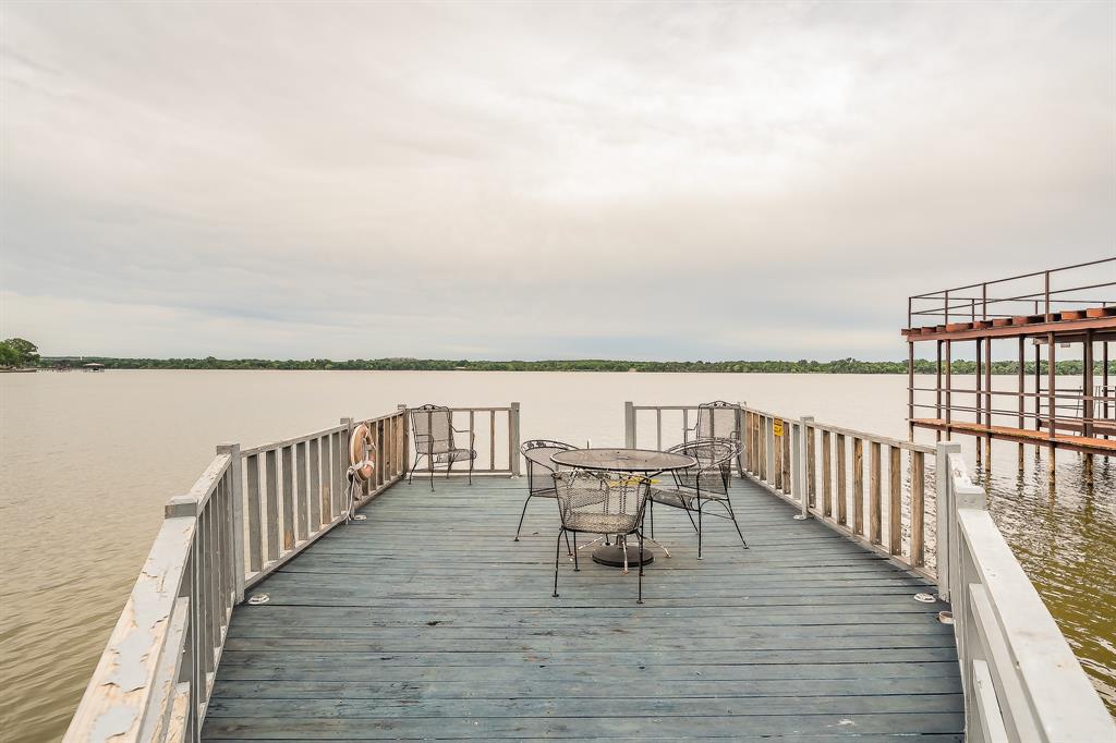 14064 Rucker Street Azle, TX 76020 - Photo 32 of 40 a roof deck with chairs and wooden floor