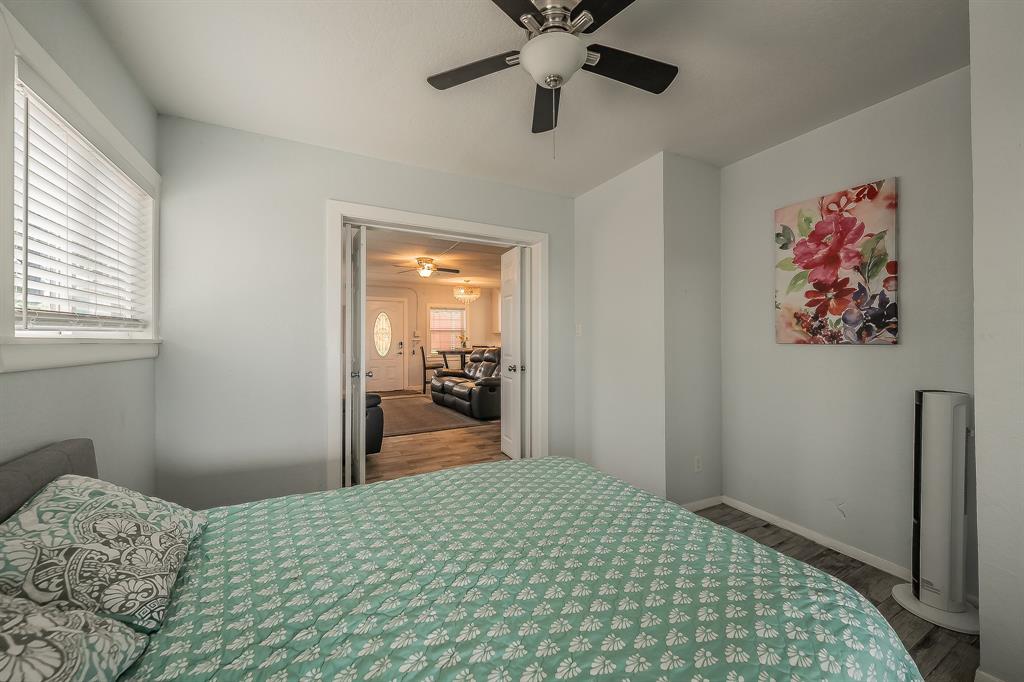14064 Rucker Street Azle, TX 76020 - Photo 36 of 40 a bedroom with a bed and a chandelier