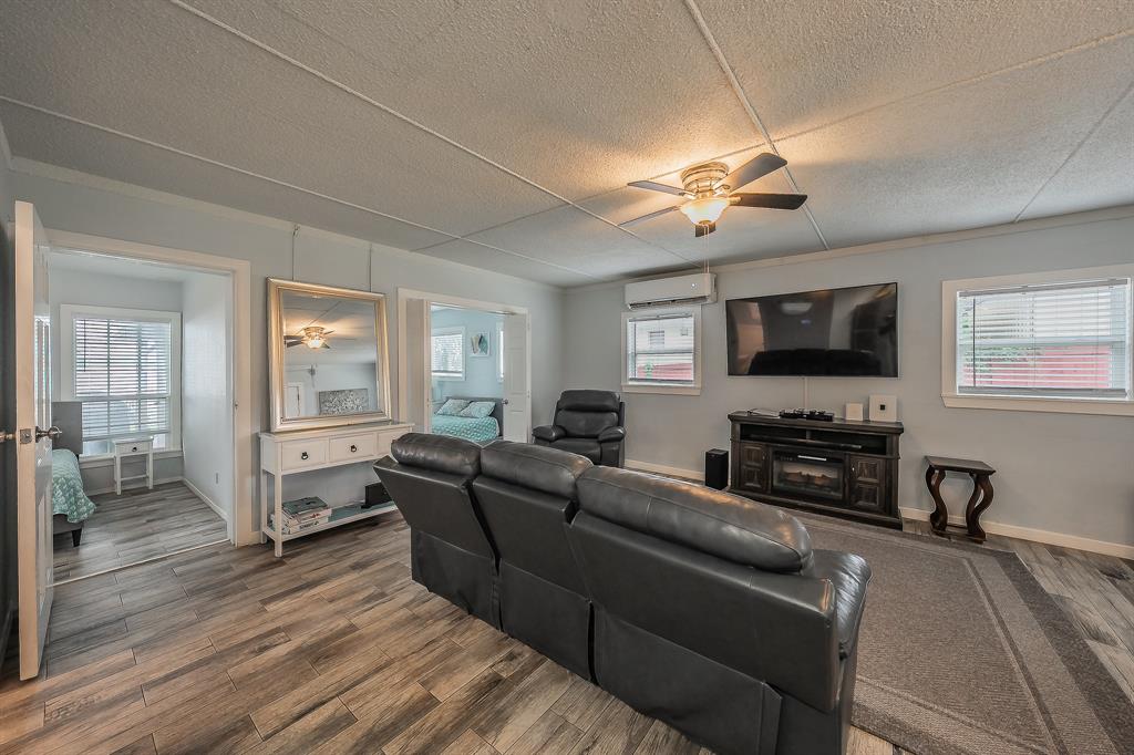 14064 Rucker Street Azle, TX 76020 - Photo 9 of 40 a living room with furniture a ceiling fan and a flat screen tv