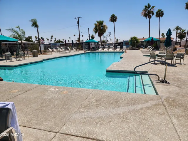 a view of a swimming pool with chairs