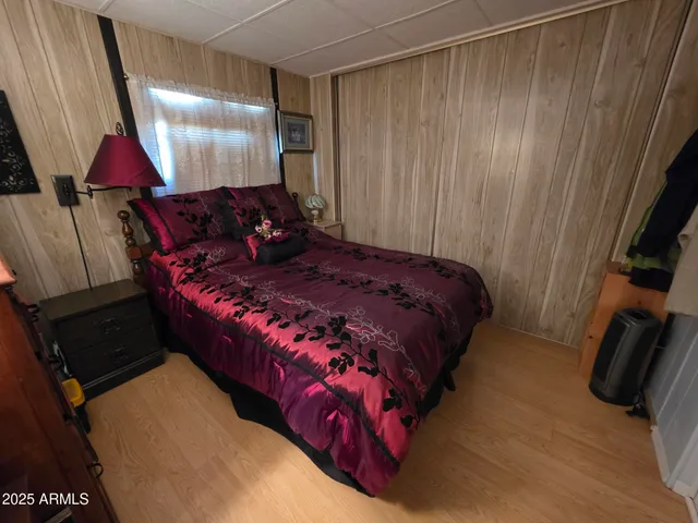 a bed sitting in a bedroom next to a window