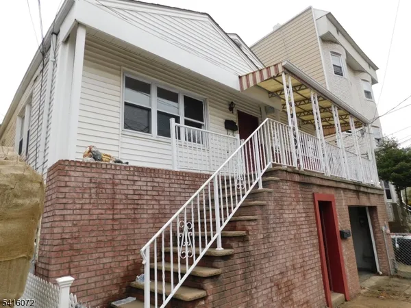 a front view of a house with wooden stairs