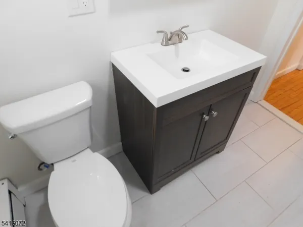 a white sink sitting next to a white toilet