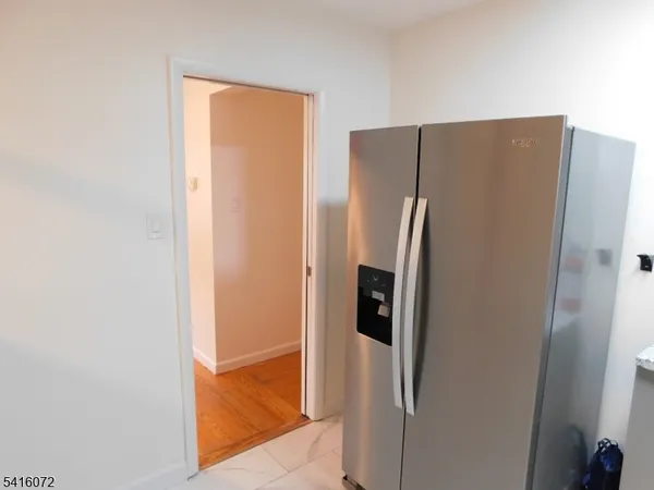 a metallic refrigerator freezer sitting in a kitchen