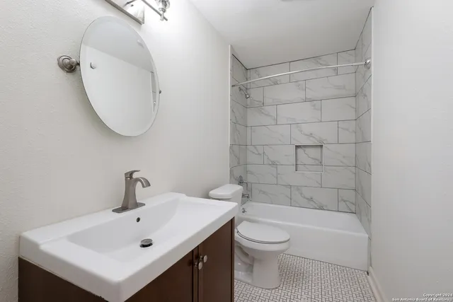 a bathroom with a sink toilet and shower