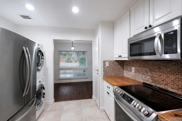 a kitchen with stainless steel appliances a stove a microwave and a refrigerator