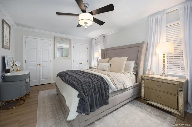 a spacious bedroom with a bed and a chandelier