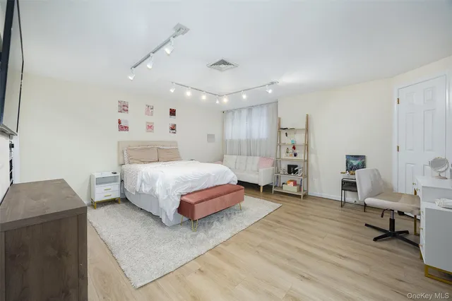 a bedroom with a bed and a couch