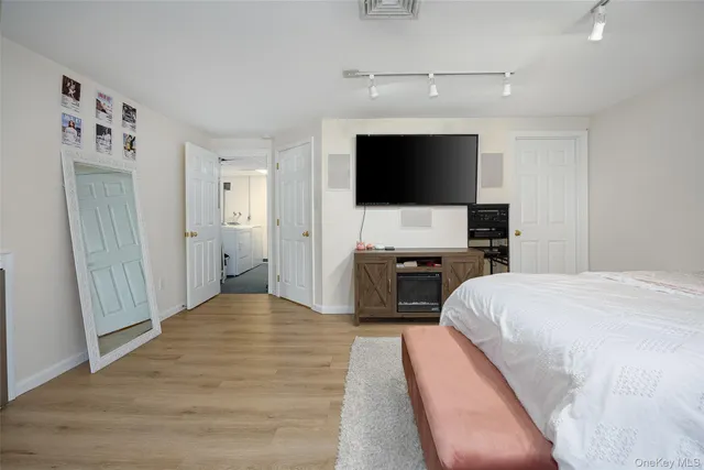 a bedroom with a bed and a flat screen tv
