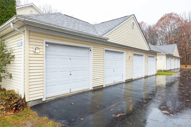 a view of a house with a yard and garage
